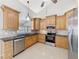 Spacious kitchen, featuring light wood cabinets and granite countertops at 2712 Mock Orange Ct, Valrico, FL 33594
