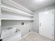 Laundry room with utility sink and built-in shelving at 2712 Mock Orange Ct, Valrico, FL 33594
