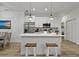 Modern white kitchen with stainless steel appliances and an island at 3038 Sargeant St, Port Charlotte, FL 33948