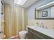 Clean bathroom with shower/tub combo, vanity, and mirror at 3421 Cantrell St, Holiday, FL 34690