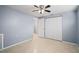 Bright bedroom featuring double closets and ceiling fan at 3421 Cantrell St, Holiday, FL 34690