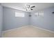 Spacious bedroom with ceiling fan and light carpeting at 3421 Cantrell St, Holiday, FL 34690