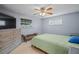 Comfortable bedroom with light green bedding and ample closet space at 3421 Cantrell St, Holiday, FL 34690