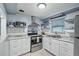Well-equipped kitchen featuring white cabinetry and stainless steel appliances at 3421 Cantrell St, Holiday, FL 34690