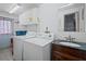 Laundry room with washer, dryer, and cabinet storage at 3421 Cantrell St, Holiday, FL 34690