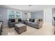 Cozy living room with gray sofas and ottoman, offering a comfortable atmosphere at 3421 Cantrell St, Holiday, FL 34690