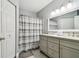 Clean bathroom with double vanity and shower/tub combo at 3607 Trafalgar Way # 103, Palm Harbor, FL 34685