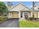 Tan two-story house with a garage and landscaped yard at 3607 Trafalgar Way # 103, Palm Harbor, FL 34685