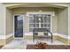 Inviting front porch with a bench, perfect for relaxing at 3607 Trafalgar Way # 103, Palm Harbor, FL 34685