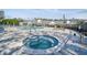 Community hot tub and surrounding patio area with lounge chairs at 3607 Trafalgar Way # 103, Palm Harbor, FL 34685