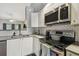 Modern kitchen with stainless steel appliances at 3607 Trafalgar Way # 103, Palm Harbor, FL 34685