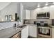 Updated kitchen with white shaker cabinets and stainless steel appliances at 3607 Trafalgar Way # 103, Palm Harbor, FL 34685
