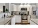 Modern kitchen with stainless steel appliances and white cabinets at 3607 Trafalgar Way # 103, Palm Harbor, FL 34685
