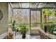 Relaxing screened porch overlooking a lush wooded area at 3607 Trafalgar Way # 103, Palm Harbor, FL 34685