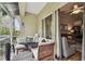 Screened porch with seating, looking out into the backyard at 3607 Trafalgar Way # 103, Palm Harbor, FL 34685
