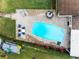 Aerial view of a kidney-shaped pool, patio furniture, and boat at 3756 E Lake Dr, Land O Lakes, FL 34639
