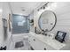 Modern bathroom with gray tile, floating vanity, and large mirror at 3756 E Lake Dr, Land O Lakes, FL 34639