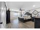 Spacious bedroom with a large bed, dark wood furniture, and tile flooring at 3756 E Lake Dr, Land O Lakes, FL 34639