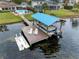 Aerial view of a pontoon boat in a covered dock at 3756 E Lake Dr, Land O Lakes, FL 34639