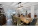 Elegant dining room featuring a rustic wood table and stylish chairs at 3756 E Lake Dr, Land O Lakes, FL 34639