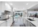 White kitchen with stainless steel appliances and sliding glass doors to the pool at 3756 E Lake Dr, Land O Lakes, FL 34639