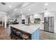 Modern kitchen boasts a large island with seating and stainless steel appliances at 3756 E Lake Dr, Land O Lakes, FL 34639