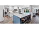 Open kitchen with a large island, white cabinets, and views of the pool at 3756 E Lake Dr, Land O Lakes, FL 34639