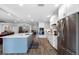 Modern kitchen with stainless steel appliances, an island, and white shaker cabinets at 3756 E Lake Dr, Land O Lakes, FL 34639