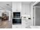 Kitchen with built-in wall oven and white shaker cabinets at 3756 E Lake Dr, Land O Lakes, FL 34639