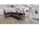 Open concept living room with a large sectional sofa and tile floors at 3756 E Lake Dr, Land O Lakes, FL 34639