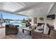 Covered patio with wicker furniture and lake view at 3756 E Lake Dr, Land O Lakes, FL 34639