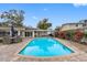 Inviting pool with a large patio and lake view at 3756 E Lake Dr, Land O Lakes, FL 34639