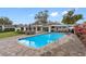 Inviting swimming pool with a large patio and lush landscaping at 3756 E Lake Dr, Land O Lakes, FL 34639