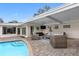 Relaxing poolside patio with covered seating area at 3756 E Lake Dr, Land O Lakes, FL 34639