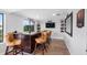 Home bar with dark wood cabinetry, tan leather barstools, and a large TV at 3756 E Lake Dr, Land O Lakes, FL 34639