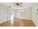Spacious bedroom with light walls, ceiling fan, and wood-look flooring at 4233 Oakfield Ave, Holiday, FL 34691