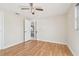 Bedroom with wood-look floors and ceiling fan at 4233 Oakfield Ave, Holiday, FL 34691