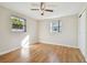 Bedroom with wood-look floors and two windows at 4233 Oakfield Ave, Holiday, FL 34691