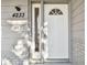 White front door with a transom window and keypad entry at 4233 Oakfield Ave, Holiday, FL 34691