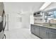 Modern kitchen with gray cabinets, granite countertops, and stainless steel appliances at 4233 Oakfield Ave, Holiday, FL 34691