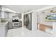 Modern kitchen with gray cabinets, granite countertops, and stainless steel appliances at 4233 Oakfield Ave, Holiday, FL 34691