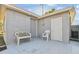 Small patio area with bench and chair, near storage shed at 4233 Oakfield Ave, Holiday, FL 34691