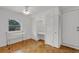 Bedroom with hardwood floors, built-in shelving and window at 4902 Stolls Ave, Tampa, FL 33615