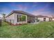 Private backyard with a patio, lush landscaping, and a modern fence at 5225 Caserta Ct, Palmetto, FL 34221