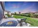 Landscaped backyard with fire pit and seating area at 5225 Caserta Ct, Palmetto, FL 34221