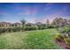 Large backyard with a grassy lawn, landscaping, and a fence at 5225 Caserta Ct, Palmetto, FL 34221