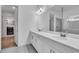 Double vanity bathroom with white cabinets, quartz countertops, and large mirror at 5225 Caserta Ct, Palmetto, FL 34221