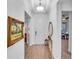 Bright and airy foyer with hardwood floors and elegant mirror at 5225 Caserta Ct, Palmetto, FL 34221