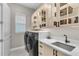 Bright laundry room with washer, dryer, and built-in cabinets at 5225 Caserta Ct, Palmetto, FL 34221