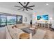 Spacious living room with large sectional sofa, a large TV, and sliding glass doors leading to the backyard at 5225 Caserta Ct, Palmetto, FL 34221